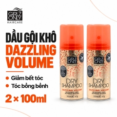 Một chai dầu gội khô Girlz Only Dazzling Volume 100ml, thân màu đồng và nắp cam.