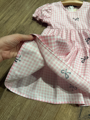 Váy caro hồng nơ đen