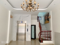 Thang Máy Khung Thép Vách Kính Inox Gương Trắng