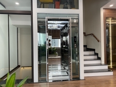 Thang Máy Khung Thép Vách Kính Inox Gương Trắng