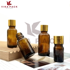 Chai thủy tinh đựng tinh dầu màu nâu nắp xoắn vàng