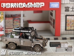 Xe Mô Hình Land Rover Defender/Tomb Raider and Rover Defender Tomb Raider Livery 1:64 DCM (Muddy Version)