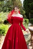 Váy cưới phi nhật trễ vai ngang tay rớt xếp ly đỏ điểm nút NCD030D