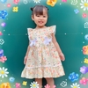 Đầm bé gái tay cánh tiên in hoa vàng cam kết nơ hai bên
