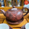 Bộ ấm chén gốm hoa đào chạm nổi