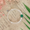 vong-tay-tre-em-charm-cau-bac-va-da-mau-xanh-la-cay-v2409110029