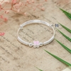 vong-tay-be-gai-charm-hoa-4-canh-hong-ket-hop-charm-xoan-oc-2-ben-v2409110028