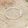 vong-tay-tre-em-hoa-tiet-gan-charm-hoa-6-canh-hong-v2409110011