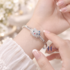 vong-tay-bac-mat-vong-hinh-hello-kitty-dinh-da-trang-deo-no-xanh-v2409050007
