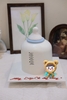 Tượng silicon-bé trai áo xanh quàng khăn.