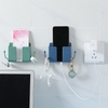 Dụng cụ để điện thoại, remote có khe dây sạc dán tường