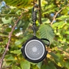 Loa mini Flextail Tiny Speaker treo trên cành cây giữa tán lá xanh
