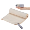 Khăn mặt đa năng Flextail Cozy Towel màu be cuộn tròn và gấp gọn cầm trên tay