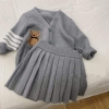 Bộ len màu ghi áo cardigan kèm chân váy xếp li thêu hình gấu bé gái