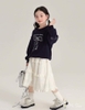 Bộ Hi.Sun áo nỉ đen dài tay mix chân váy thô trắng họa tiết nơ