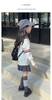 Áo len dệt Thom Browne tay cài cúc 2 màu trắng, xám cho bé