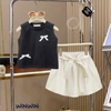 Bộ WinWin 3-8Y Nexxi áo thun sát nách croptop 2 màu hồng, đen đính nơ chân váy kate xoè