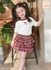 Bộ cộc tay áo trắng nơ Cocso JAM&JENNY mix chân váy ĐỎ caro 3 tầng
