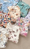 Bộ Pyjama Qibao trắng hình bé gái tóc nâu nơ đỏ