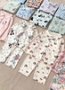 Bộ Pyjama Qibao trắng hình bé gái tóc nâu nơ đỏ