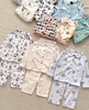 Bộ Pyjama Qibao trắng hình bé gái tóc nâu nơ đỏ