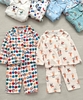 Bộ Pyjama Qibao trắng hình bé gái tóc nâu nơ đỏ