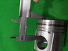 PISTON 6D114 IZUMI N66 ĐỈNH NHỌN THÂN TRẮNG KẸP THÉP